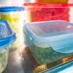 Food leftovers in sealed clear containers inside a refrigerator